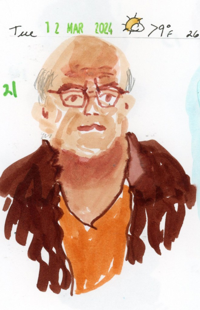 A single sketchbook page featuring portrait number 21, drawn from life with the Faber-Castell Goldfaber Aqua Dual Marker Portrait set. A bald man with glasses wears an orange shirt under a dark brown jacket. A handwritten date stamp at the top reads Tuesday, March 12, 2024.