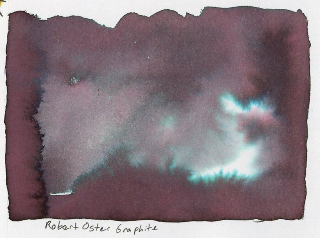 A large dramatic ink wash swatch on white sketchbook paper labeled Robert Oster Graphite below. The wash is a deep dark purple-brown with vivid teal and turquoise chromatography blooms spreading through the pigment as the ink dried, creating an atmospheric landscape-like effect with bright teal highlights against the dark base. Stillman and Birn Alpha sketchbook.